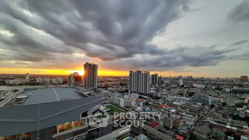 Stunning cityscape view at sunset with high-rise buildings and dramatic clouds.