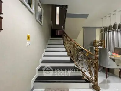 Elegant staircase with ornate railing in modern home interior