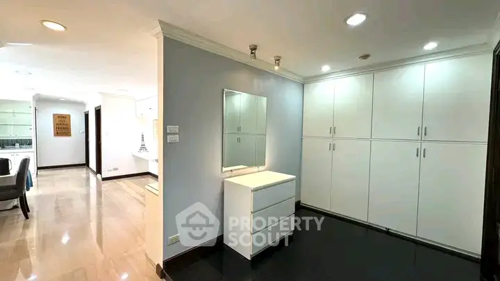 Spacious modern interior with sleek cabinetry and elegant lighting, perfect for stylish living.