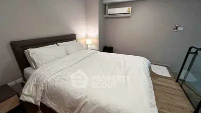 Cozy bedroom with modern decor and air conditioning, perfect for relaxation.