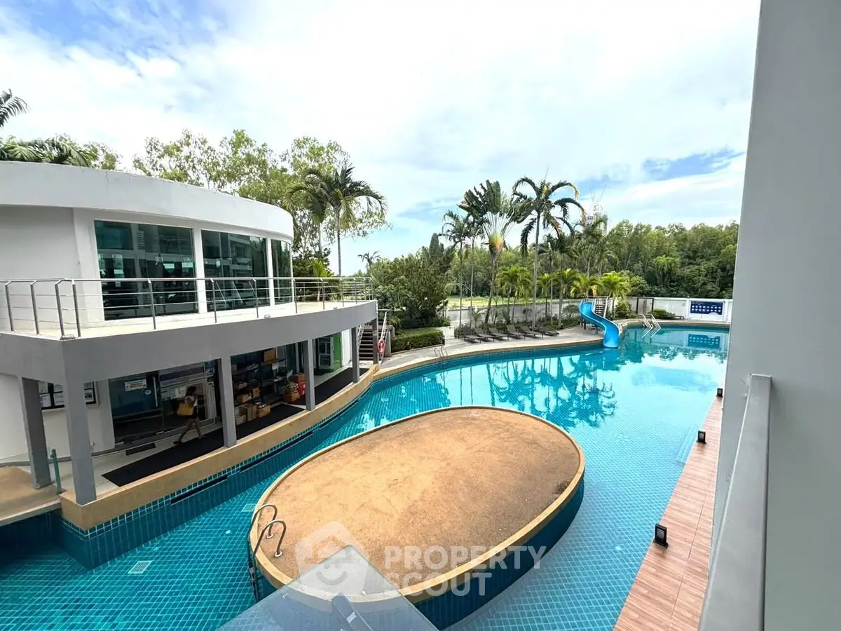 Luxurious poolside view with modern architecture and lush greenery, perfect for relaxation and leisure.