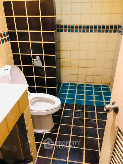 Charming bathroom with colorful tile design and modern fixtures, perfect for a cozy home.