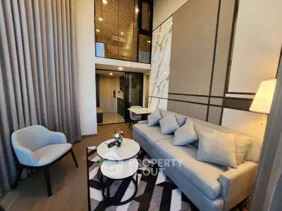 Modern living room with stylish decor and mezzanine level, featuring a cozy sofa and elegant lighting.