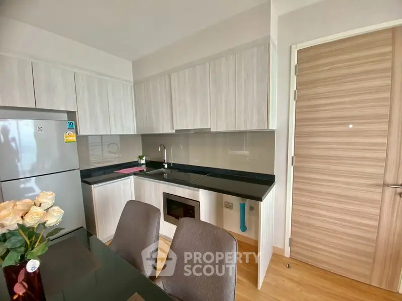 Modern kitchen with sleek cabinetry and built-in appliances in a stylish apartment.
