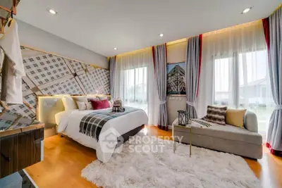 Luxurious bedroom with modern decor and large windows offering natural light.