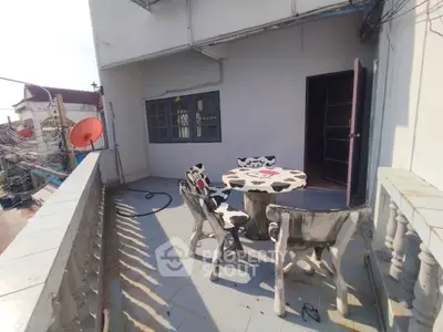 Spacious balcony with unique cow-patterned furniture, perfect for outdoor relaxation and entertainment.