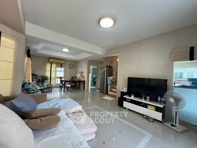 Spacious living room with modern decor and open dining area