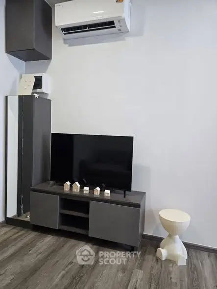 Modern living room with sleek TV stand and air conditioning unit, perfect for contemporary living.