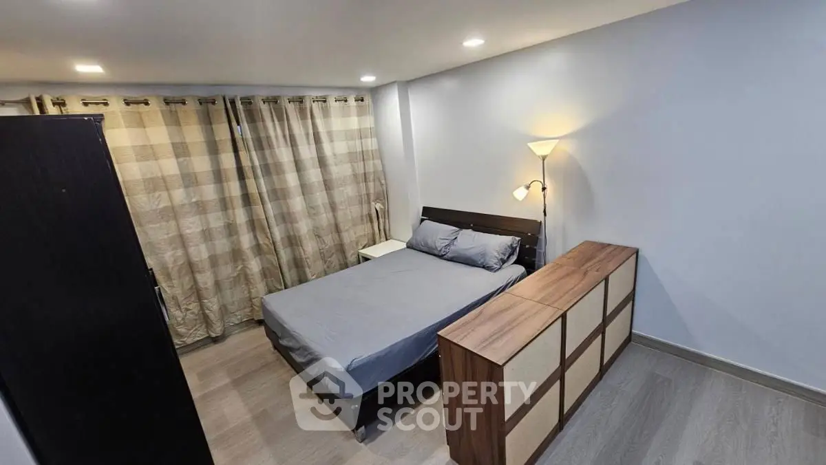 Cozy bedroom with modern furnishings and ample natural light