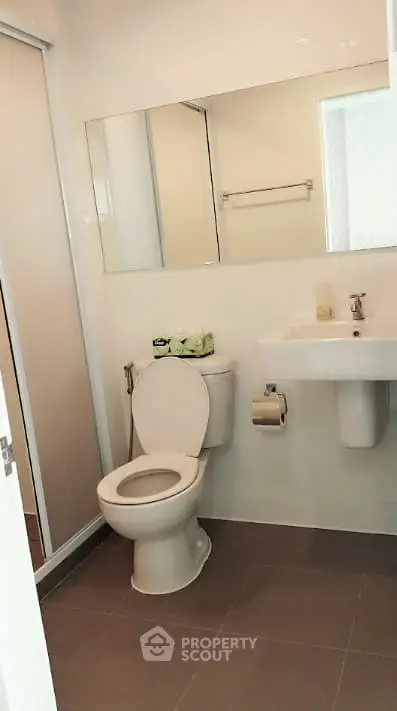 Modern bathroom with sleek fixtures and neutral tones, perfect for a contemporary home.
