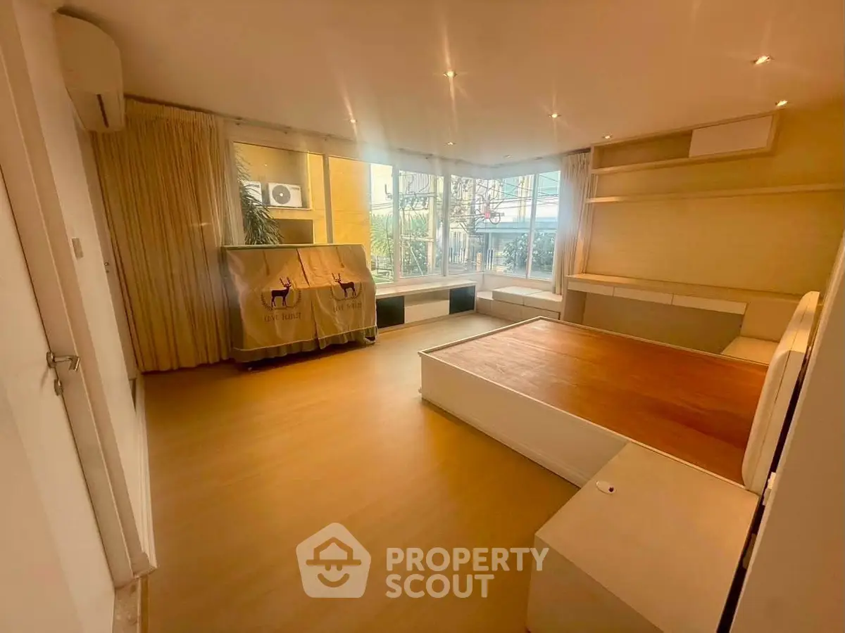 Spacious living room with large windows and modern design, perfect for natural light lovers.