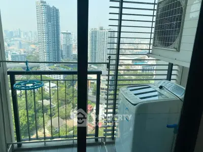 High-rise apartment balcony with city view and washing machine.