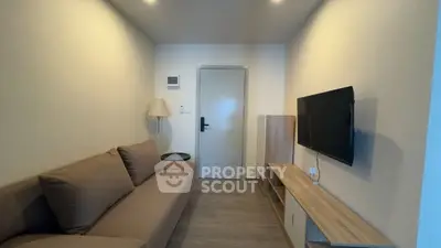 Cozy living room with modern decor and wall-mounted TV