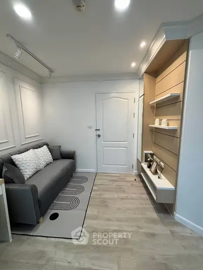 Modern living room with stylish decor and cozy seating in a contemporary apartment.