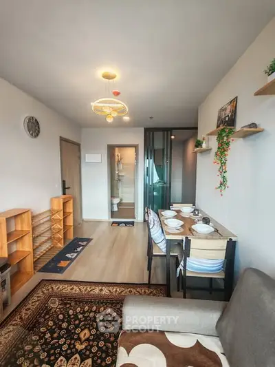 Modern living room with dining area and stylish decor in a cozy apartment.