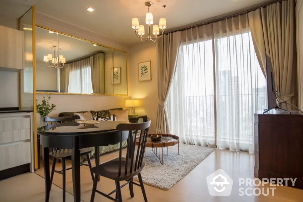 Elegant living room with large window and modern decor in a high-rise apartment.