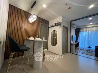 Modern living room with stylish decor and open layout, featuring elegant lighting and contemporary furniture.