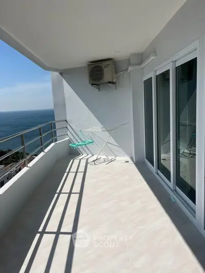 Spacious balcony with ocean view and modern sliding doors