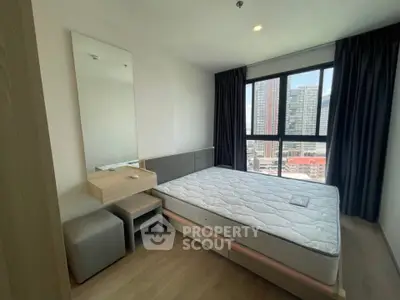 Modern bedroom with large window and city view, featuring a stylish bed and minimalist decor.