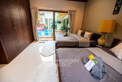 Luxurious bedroom with pool view and elegant decor