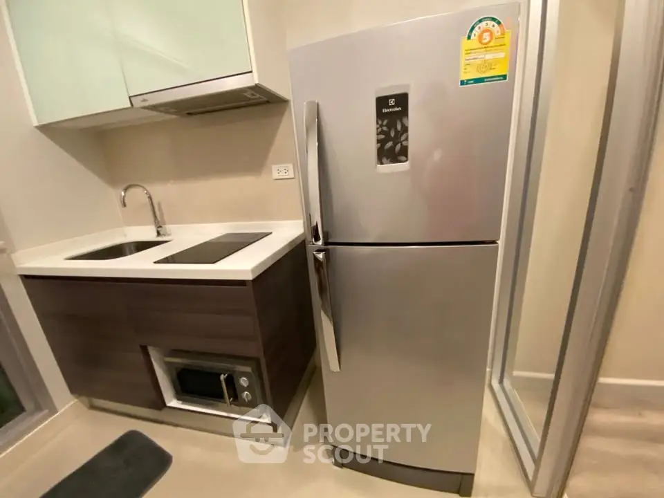 Modern kitchen with sleek refrigerator and built-in microwave