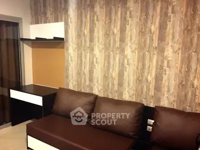 Modern living room with stylish wood panel wall and sleek furniture design.