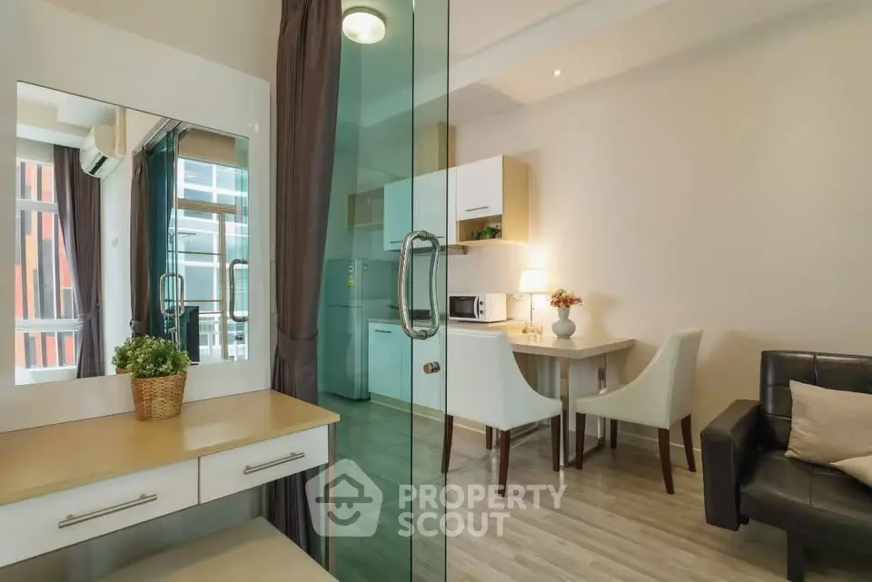 Modern open-plan living room with dining area and kitchen in stylish apartment.