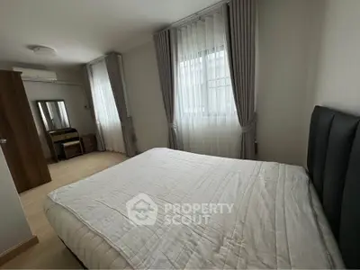 Spacious bedroom with modern decor and natural light