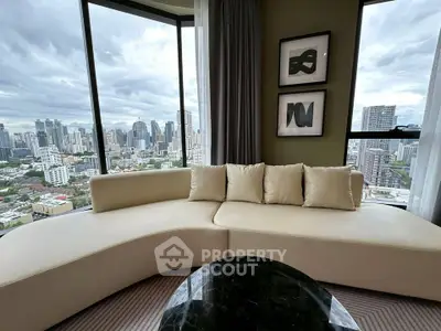 Luxurious living room with panoramic city view and elegant curved sofa.