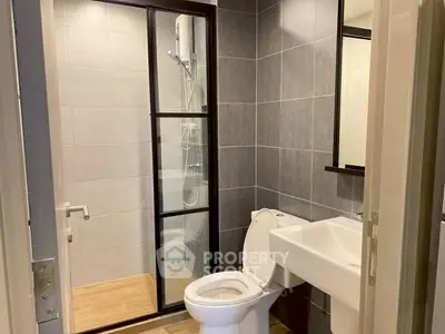 Modern bathroom with glass shower door and sleek fixtures