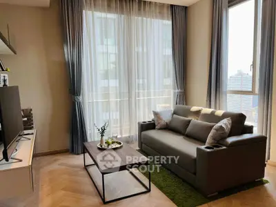 Modern living room with elegant decor and city view, featuring a cozy sofa and stylish coffee table.