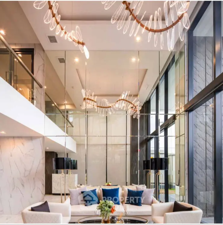 Luxurious modern living room with high ceilings and elegant chandelier