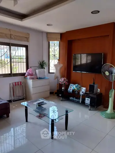 Spacious living room with modern decor and large windows for natural light.