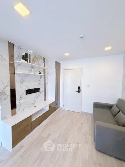 Modern living room with marble accents and sleek furniture in a stylish apartment.
