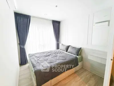 Modern bedroom with elegant decor and natural light, featuring a cozy bed and stylish curtains.