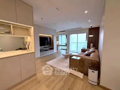 Spacious modern living room with elegant decor and city view, featuring a cozy sofa and stylish lighting.