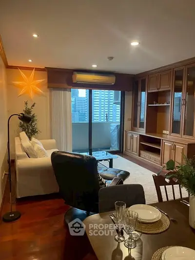Spacious living room with city view, elegant wooden cabinetry, and cozy seating area.