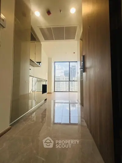 Modern apartment hallway with glossy tiles and city view