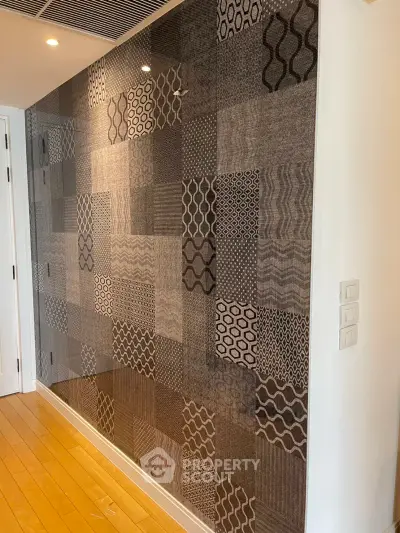 Stylish modern interior wall with unique patterned tiles and wooden flooring