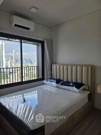 Modern bedroom with city view and air conditioning in high-rise apartment