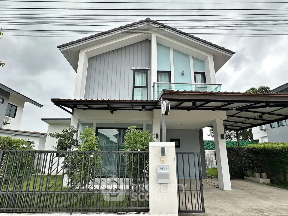 Modern two-story house with sleek design and spacious driveway in a suburban neighborhood.