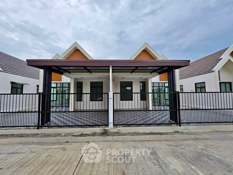 Modern duplex house with sleek design and spacious driveway, perfect for family living.
