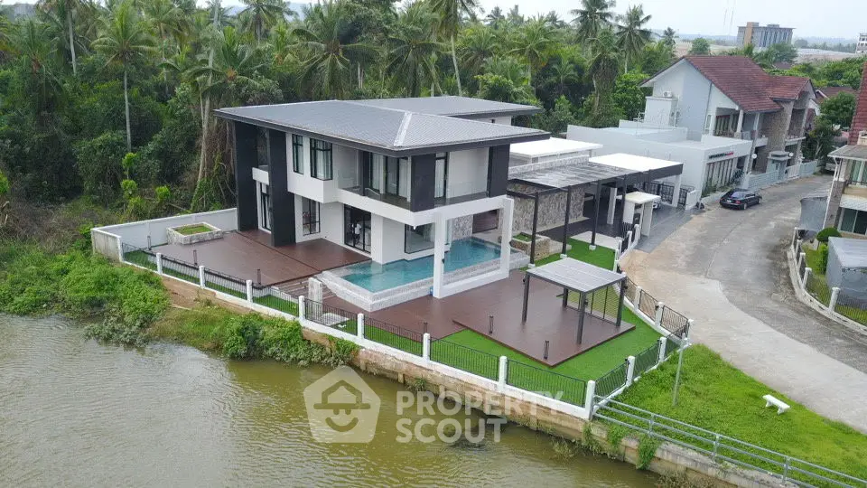 Luxurious riverside villa with modern architecture and private pool