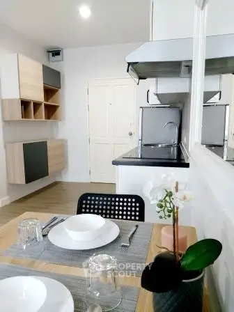 Modern kitchen with sleek design and dining area, featuring open layout and contemporary decor.