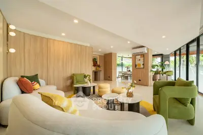 Luxurious modern living room with stylish furniture and large windows offering natural light.