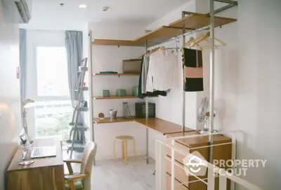 Modern study room with stylish wooden shelves and desk, natural light from large window.