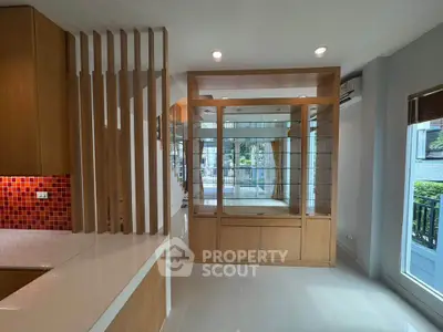 Spacious modern living area with wooden accents and ample natural light, perfect for stylish urban living.