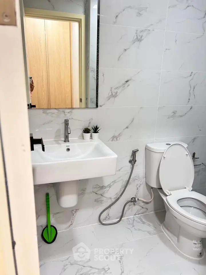 Modern bathroom with marble tiles and sleek fixtures