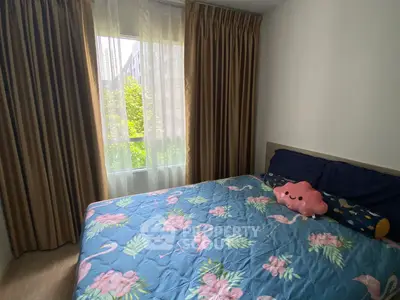 Cozy bedroom with floral bedding and large window view