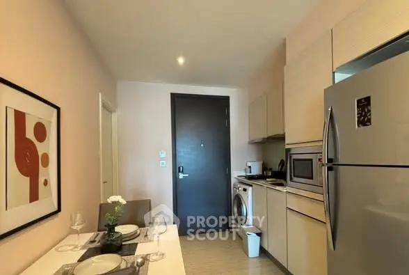 Modern kitchen with sleek appliances and stylish dining area